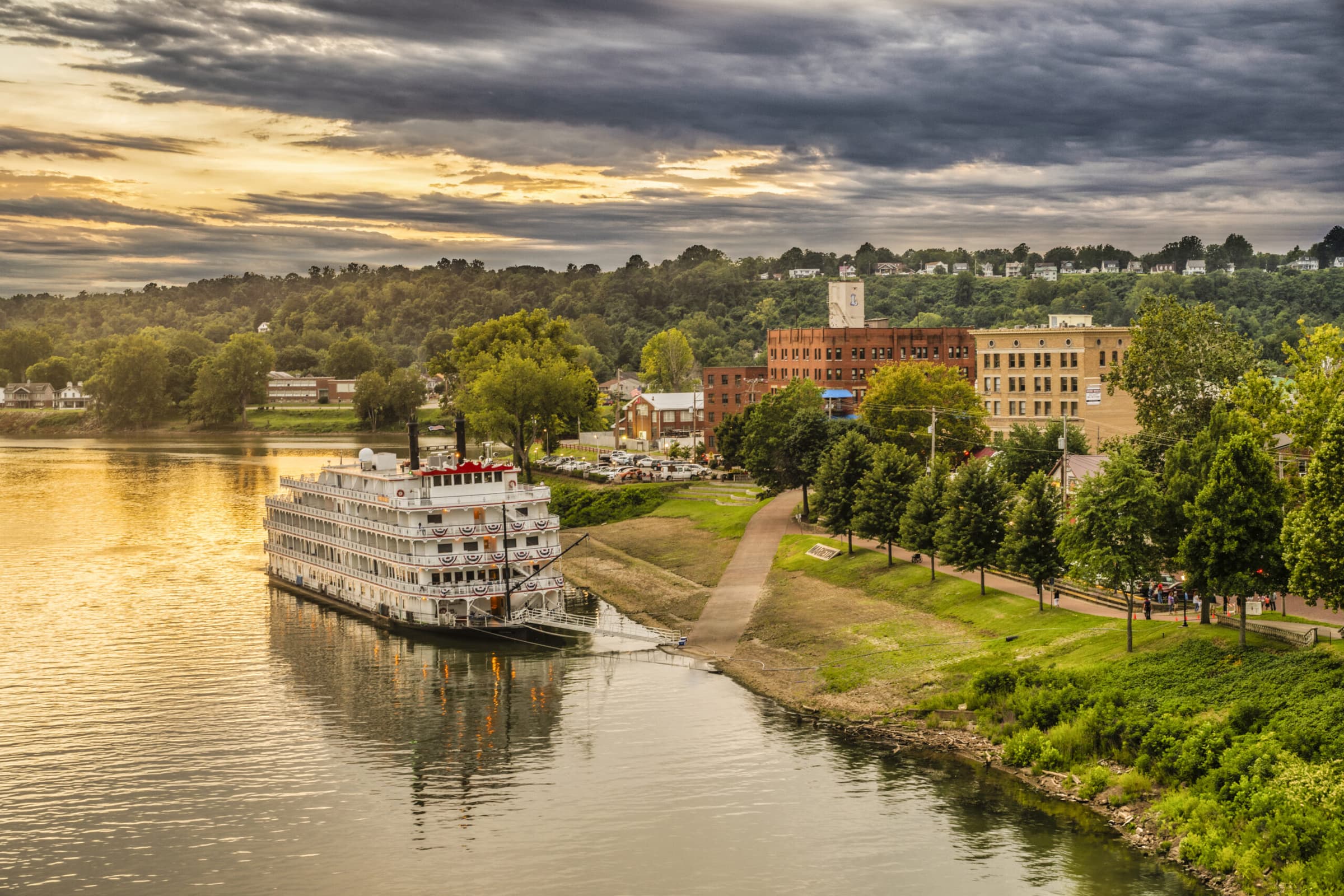 The Marietta riverfront at sunset, with a paddle steamer moored along the Ohio River